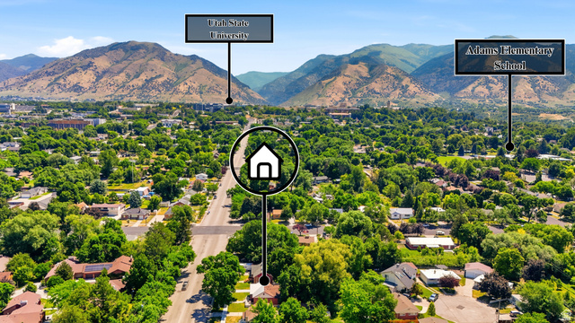 270 East 700 North Logan, UT 84321 - Photo 41 of 42 Aerial perspective showcasing a residential neighborhood with abundant mature trees and mountainous backdrops