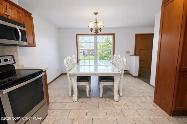 a dining room with furniture and window