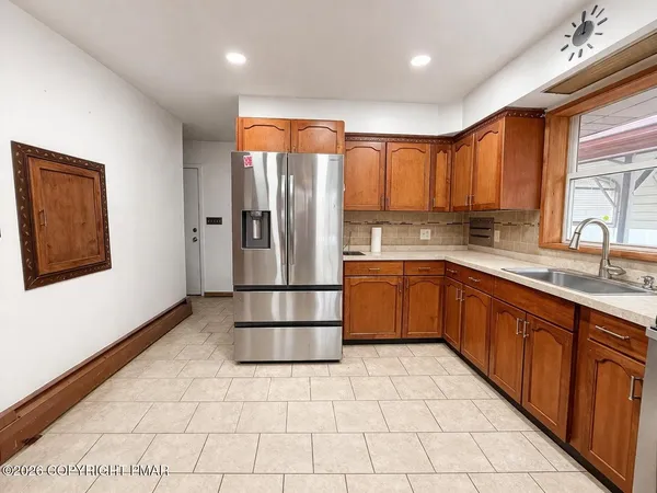 a kitchen with stainless steel appliances granite countertop a refrigerator sink and cabinets