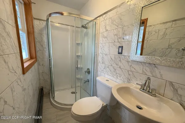 a bathroom with a toilet sink and shower