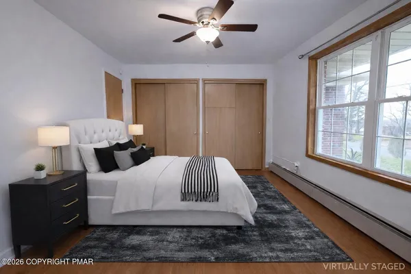 a bedroom with a bed lamp and window