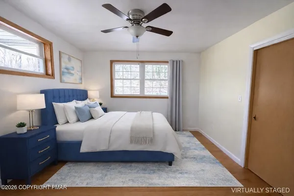 a spacious bedroom with a bed and a window