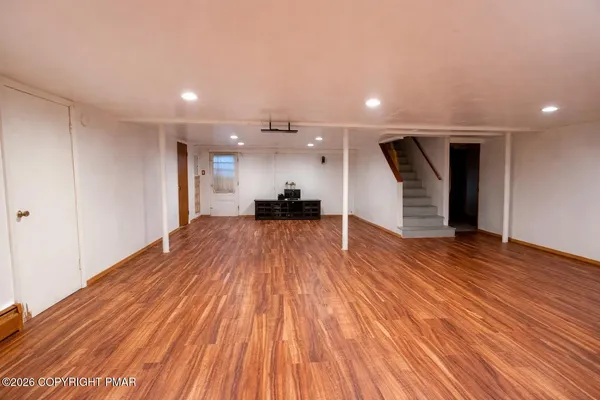 a view of a room with wooden floor