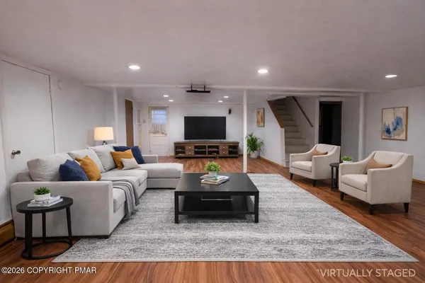 a living room with furniture and a flat screen tv