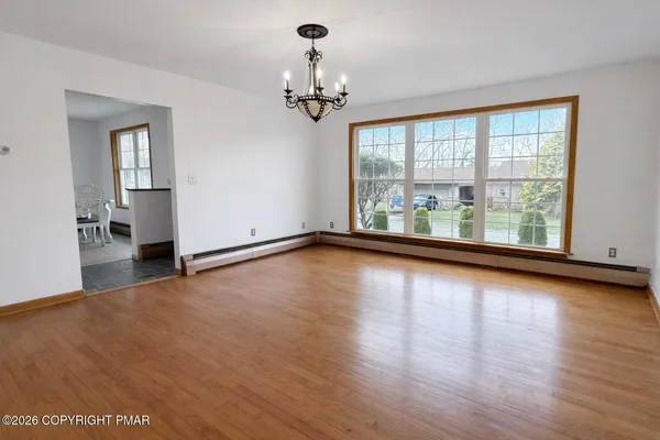 a view of room with window and wooden floor