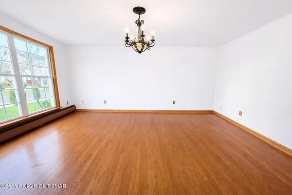 wooden floor in an empty room with a window