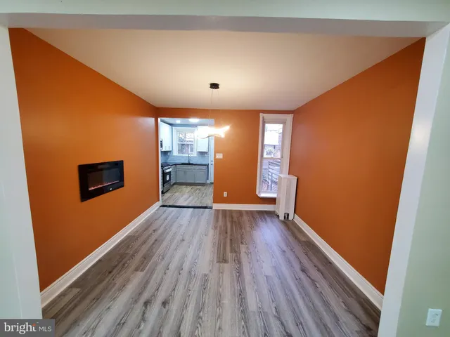 a view of a livingroom with wooden floor and a ceiling fan