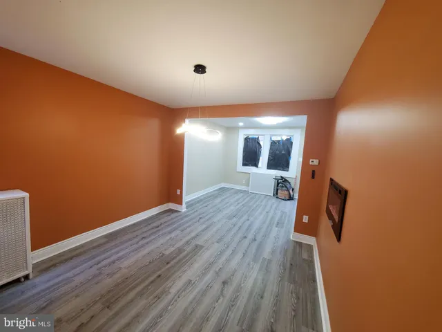 a large kitchen with stainless steel appliances granite countertop a stove a sink dishwasher a microwave oven and a refrigerator with wooden floor