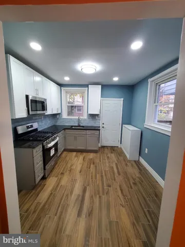 a kitchen with granite countertop a stove and a refrigerator