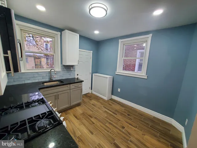 wooden floor in an empty room with a mirror