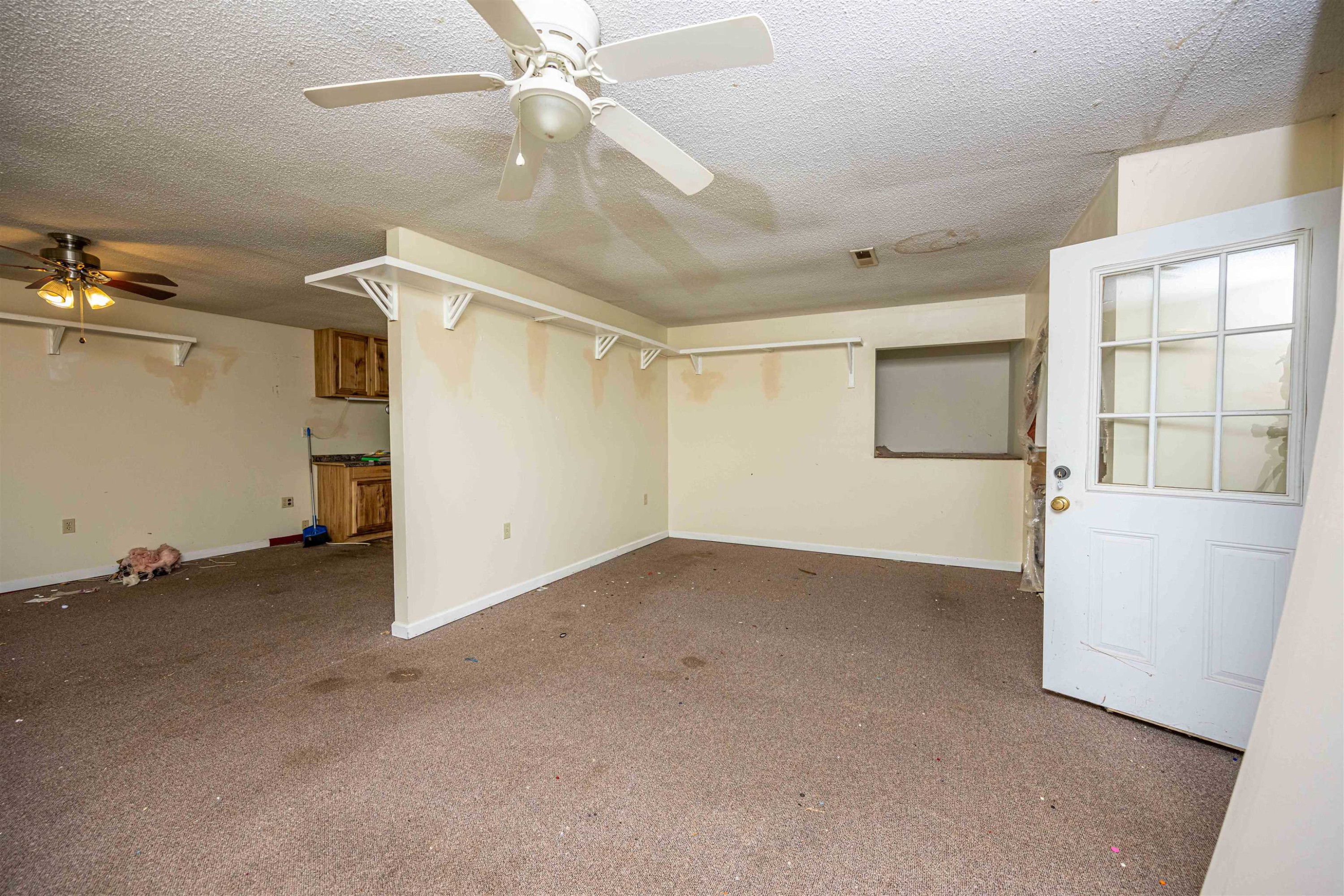 800 Bob's Landing Road Bath Springs, TN 38311 - Photo 38 of 48 an empty room with chandelier fan and windows