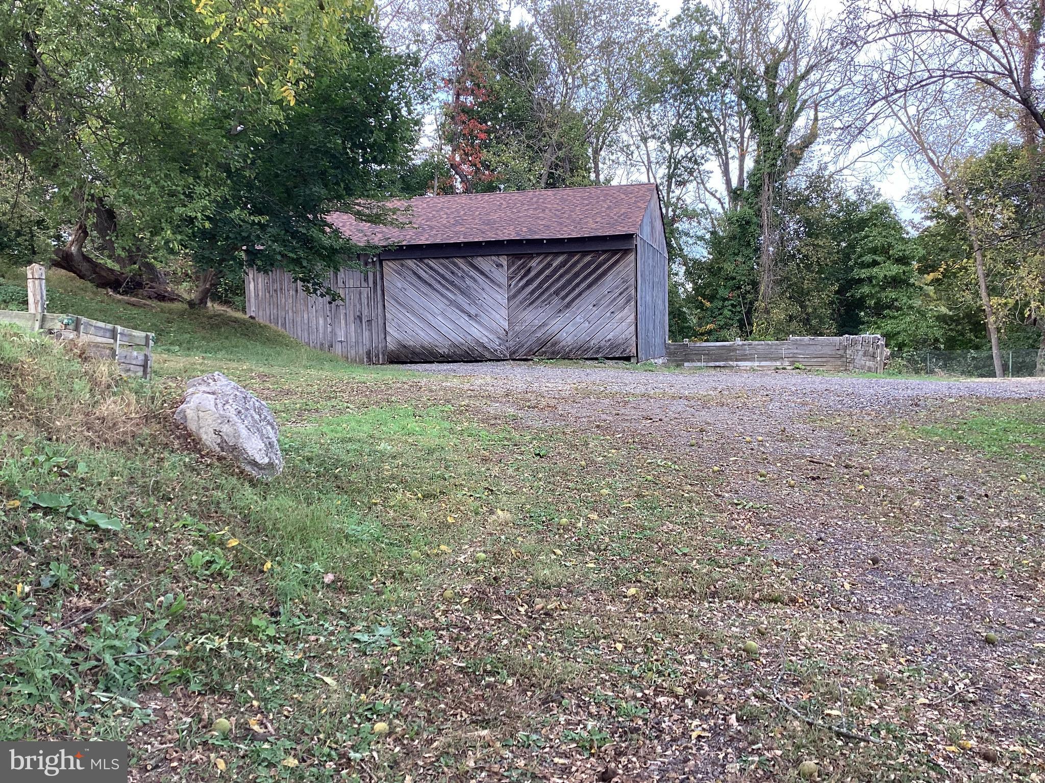 1050 Pike Springs Road, Unit BARN Phoenixville, PA 19460 - Photo 2 of 8 a wooden fence with some trees in the background