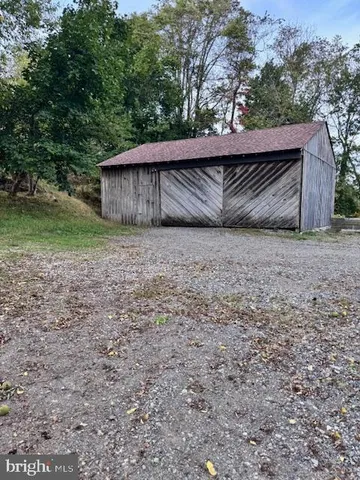 a view of backyard and wooden fence