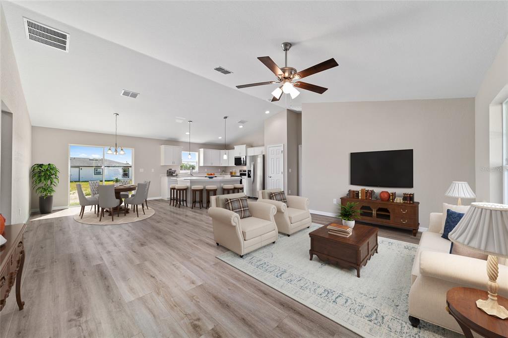 17604 Southwest 112th Lane Dunnellon, FL 34432 - Photo 2 of 23 a living room with furniture and a flat screen tv with wooden floor