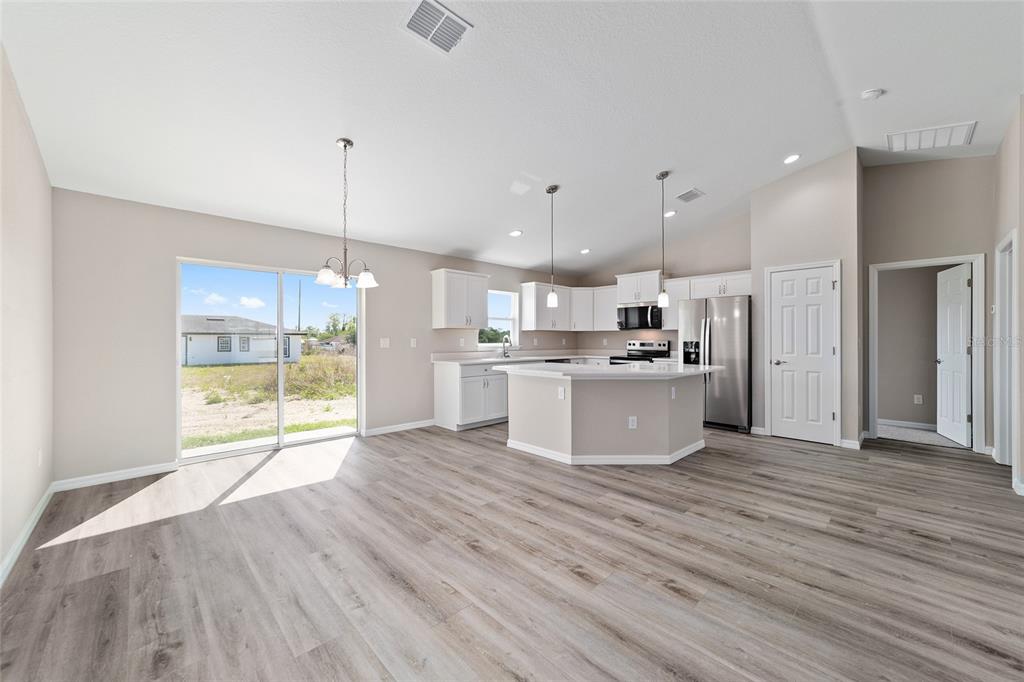 17604 Southwest 112th Lane Dunnellon, FL 34432 - Photo 4 of 23 a view of kitchen and kitchen with wooden floor