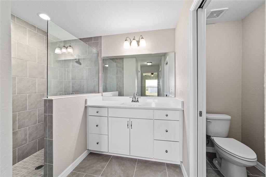 17604 Southwest 112th Lane Dunnellon, FL 34432 - Photo 8 of 23 a bathroom with a double vanity sink mirror and toilet