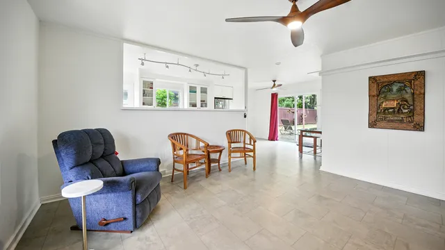 a living room with furniture and a dining table