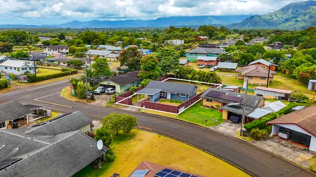 an aerial view of residential building with parking