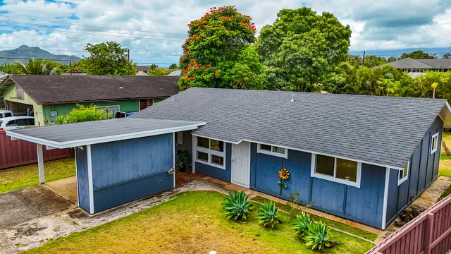 a aerial view of a house with swimming pool in front of it