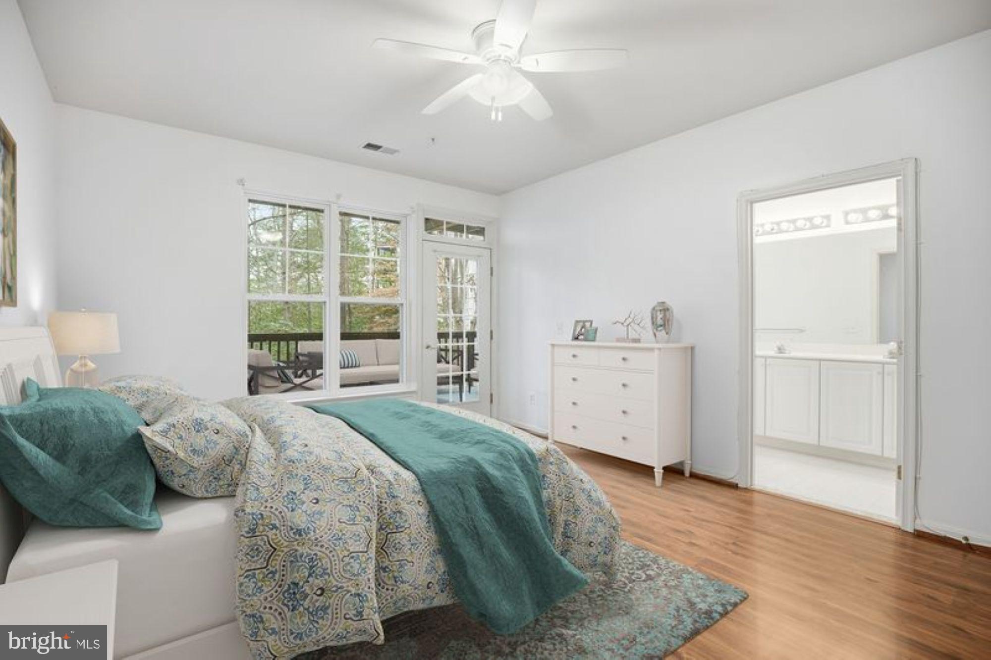 1003 Leeward Way, Unit 1003 Solomons, MD 20688 - Photo 11 of 33 Primary suite virtually staged w/deck door