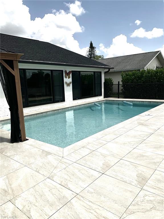 1344 Monarch Circle Naples, FL 34116 - Photo 17 of 33 a view of swimming pool with an outdoor space
