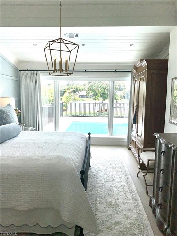 1344 Monarch Circle Naples, FL 34116 - Photo 24 of 33 a large bedroom with wooden floor