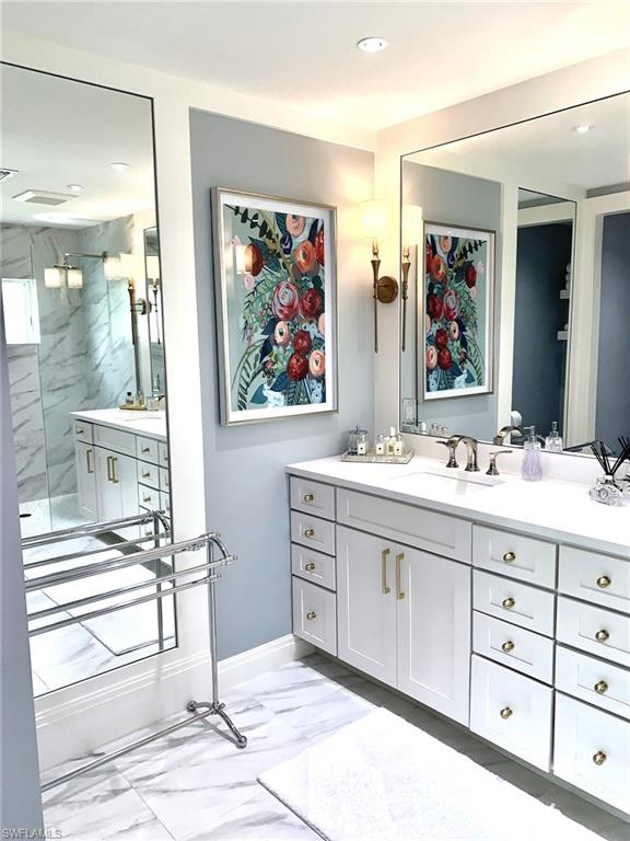 1344 Monarch Circle Naples, FL 34116 - Photo 26 of 33 a spacious bathroom with double vanity sink a mirror a glass door and shower