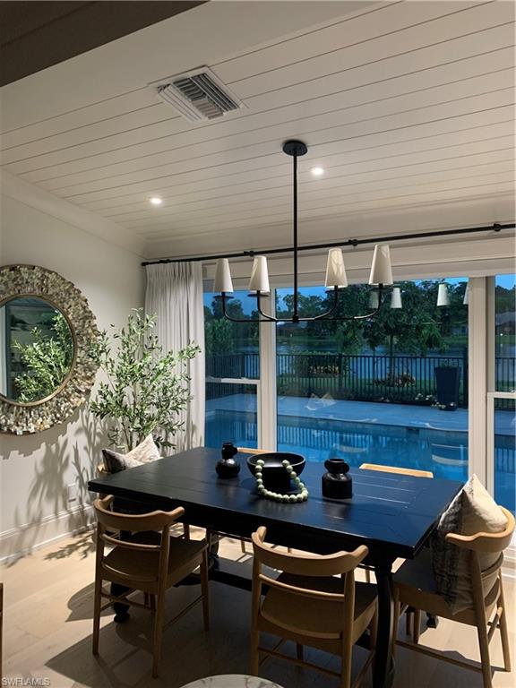 1344 Monarch Circle Naples, FL 34116 - Photo 28 of 33 a view of a patio with a table chairs and a grill