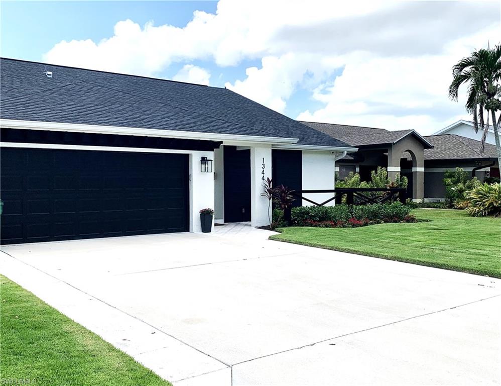 1344 Monarch Circle Naples, FL 34116 - Photo 32 of 33 a house view with a garden space