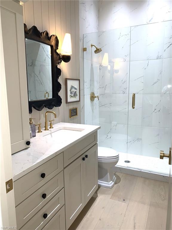 1344 Monarch Circle Naples, FL 34116 - Photo 7 of 33 a bathroom with a double vanity sink toilet and shower