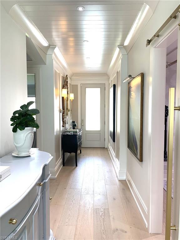 1344 Monarch Circle Naples, FL 34116 - Photo 9 of 33 a view of a hallway with wooden floor and furniture