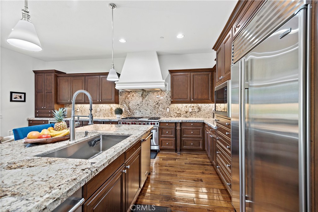 11 Pisano Street Ladera Ranch, CA 92694 - Photo 14 of 47 a kitchen with a sink stove and refrigerator