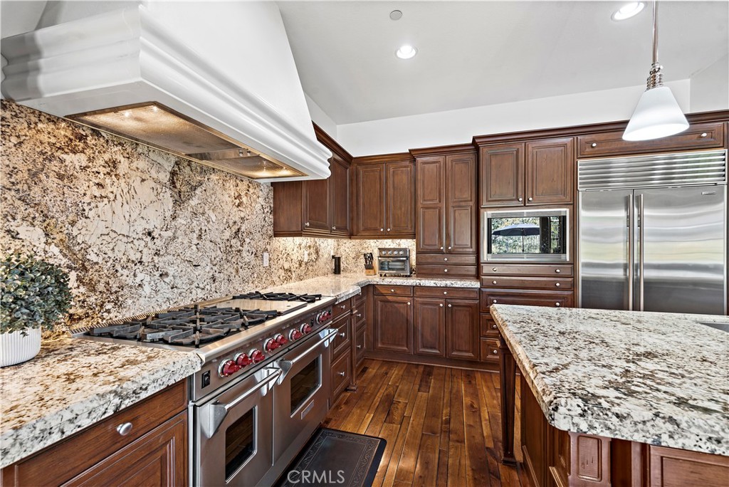 11 Pisano Street Ladera Ranch, CA 92694 - Photo 17 of 47 a kitchen with stainless steel appliances granite countertop a stove and a sink