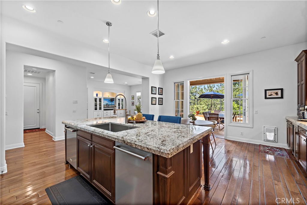 11 Pisano Street Ladera Ranch, CA 92694 - Photo 18 of 47 a kitchen that has a lot of cabinets a sink and wooden floor