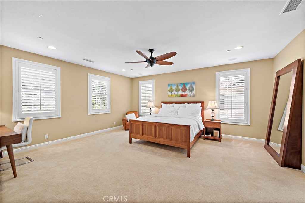 11 Pisano Street Ladera Ranch, CA 92694 - Photo 22 of 47 a spacious bedroom with a bed and a window