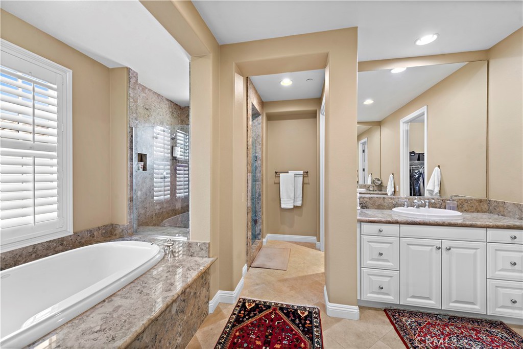 11 Pisano Street Ladera Ranch, CA 92694 - Photo 24 of 47 a spacious bathroom with a granite countertop tub sink and mirror