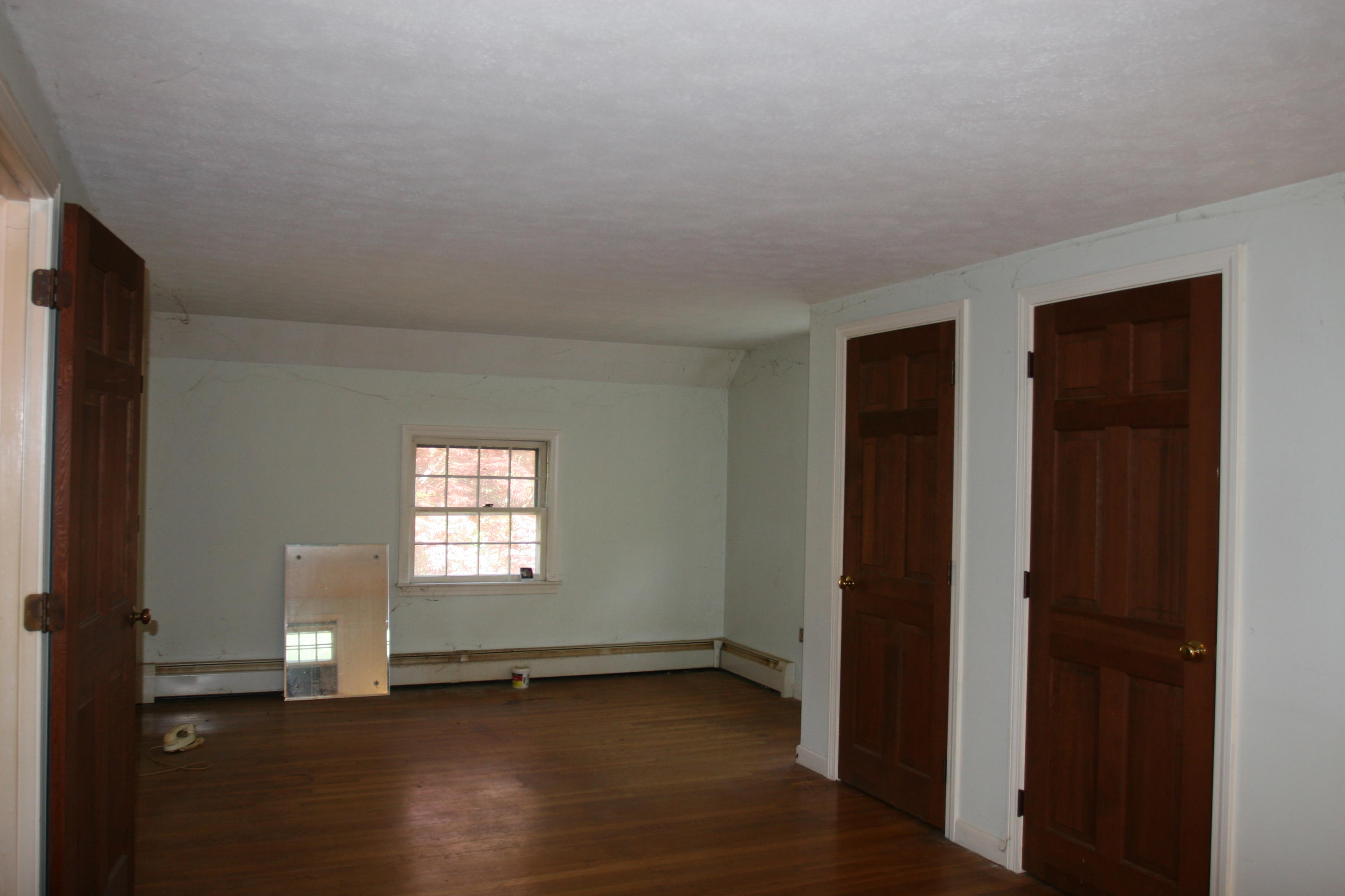 117 Turtleback Road Marstons Mills, MA 02648 - Photo 19 of 35 an empty room with wooden floor and window