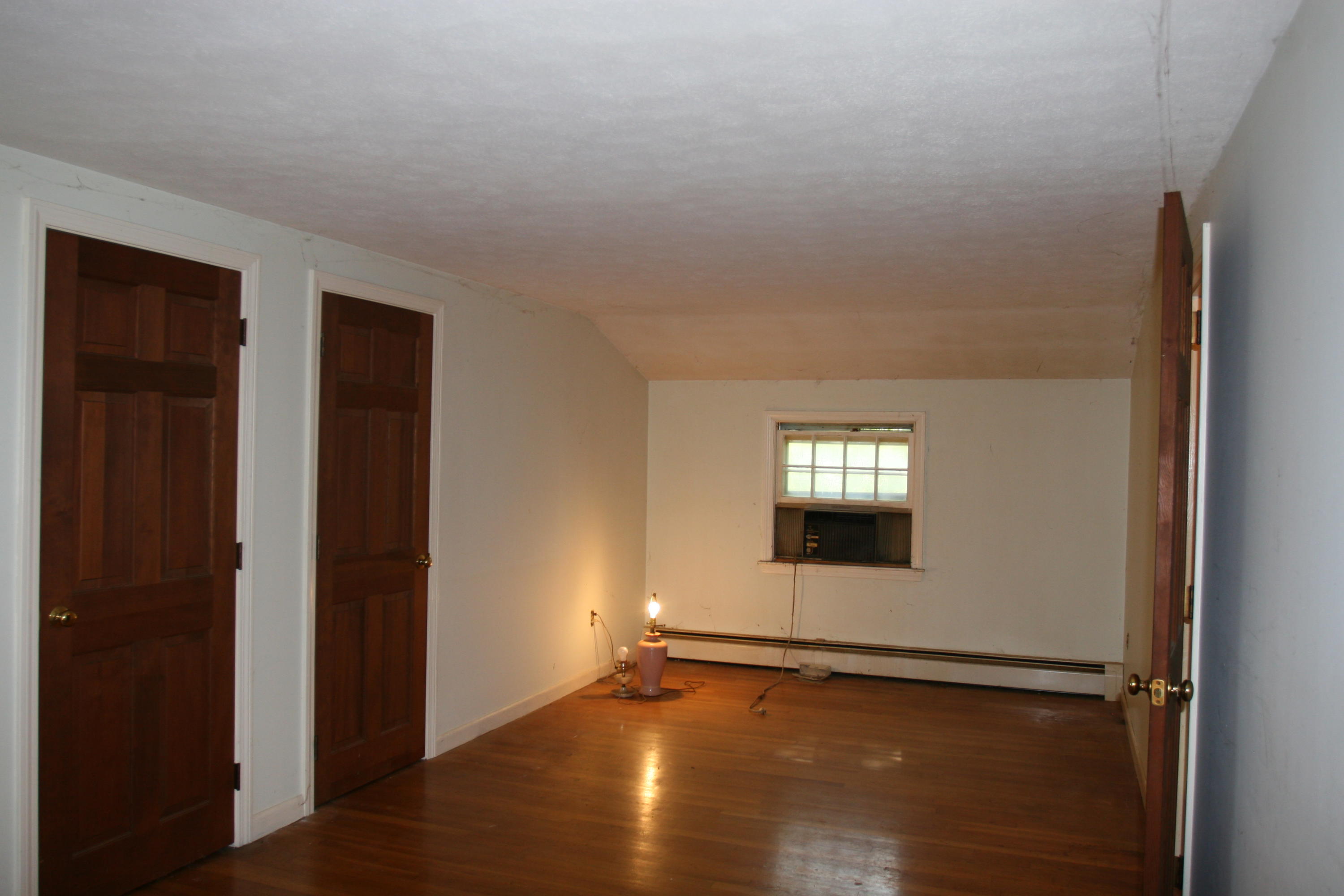 117 Turtleback Road Marstons Mills, MA 02648 - Photo 20 of 35 an empty room with wooden floor and windows