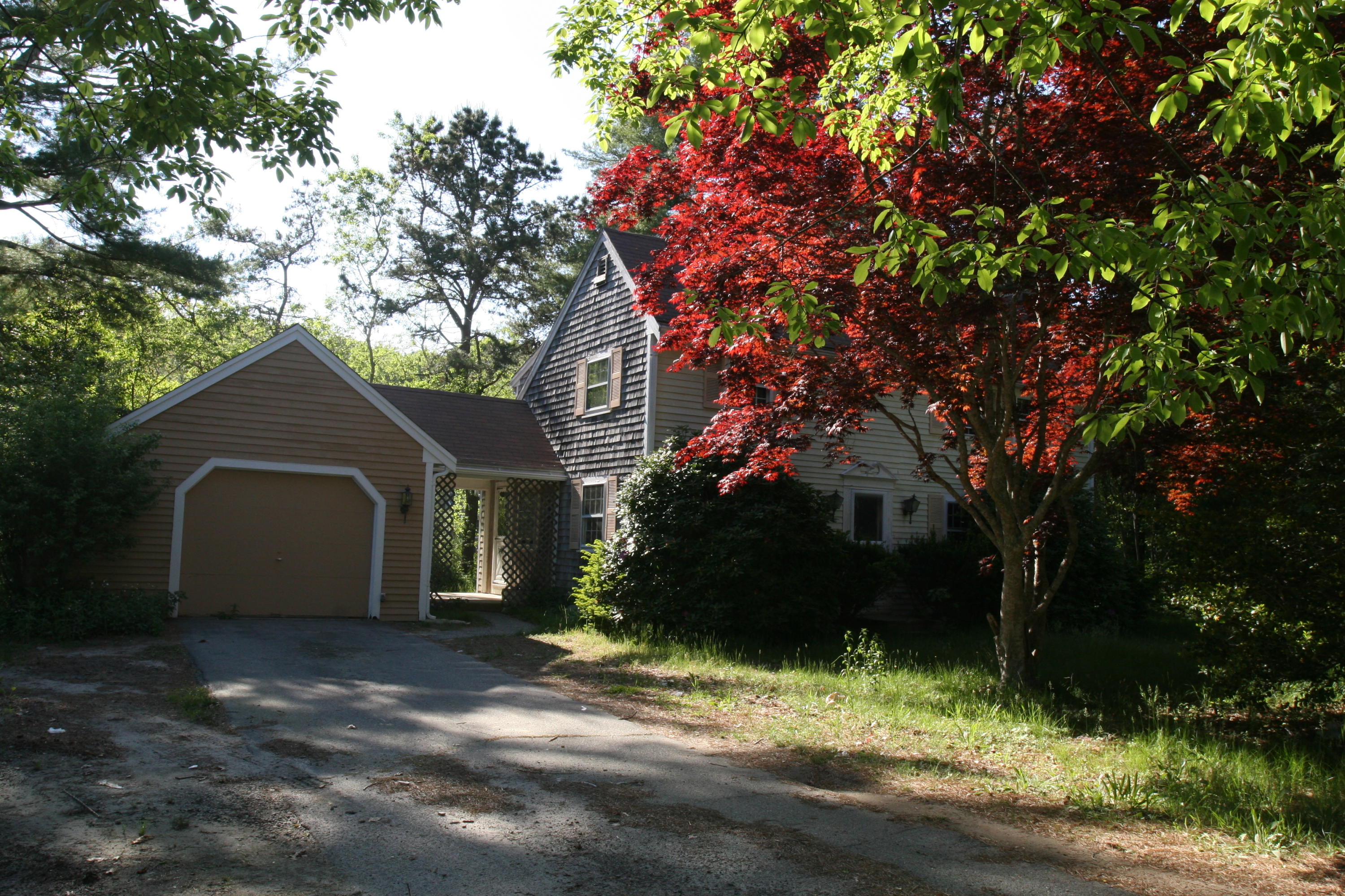 117 Turtleback Road Marstons Mills, MA 02648 - Photo 24 of 35 a front view of a house with a yard and garage
