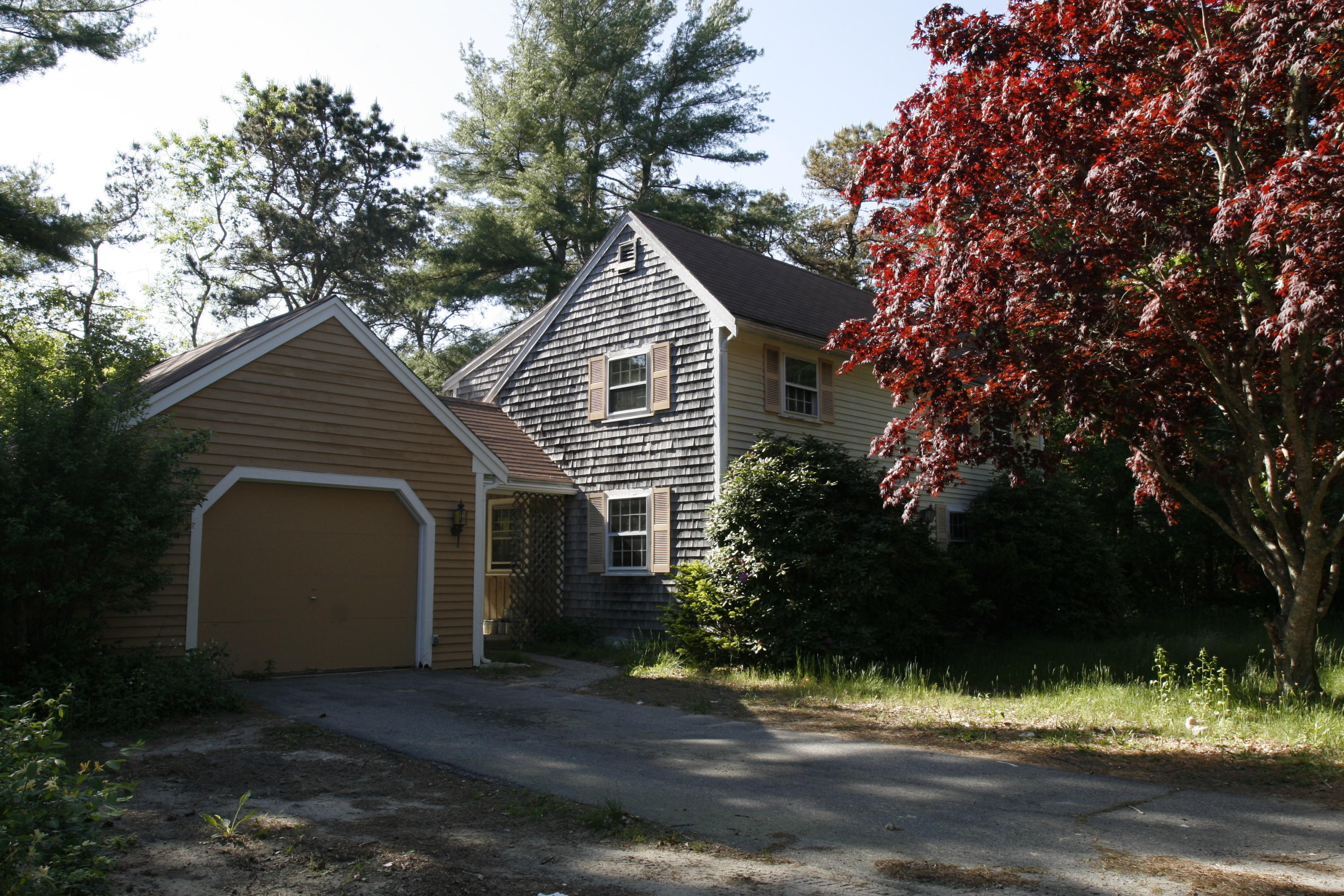 117 Turtleback Road Marstons Mills, MA 02648 - Photo 32 of 35 a front view of a house with a yard and garage