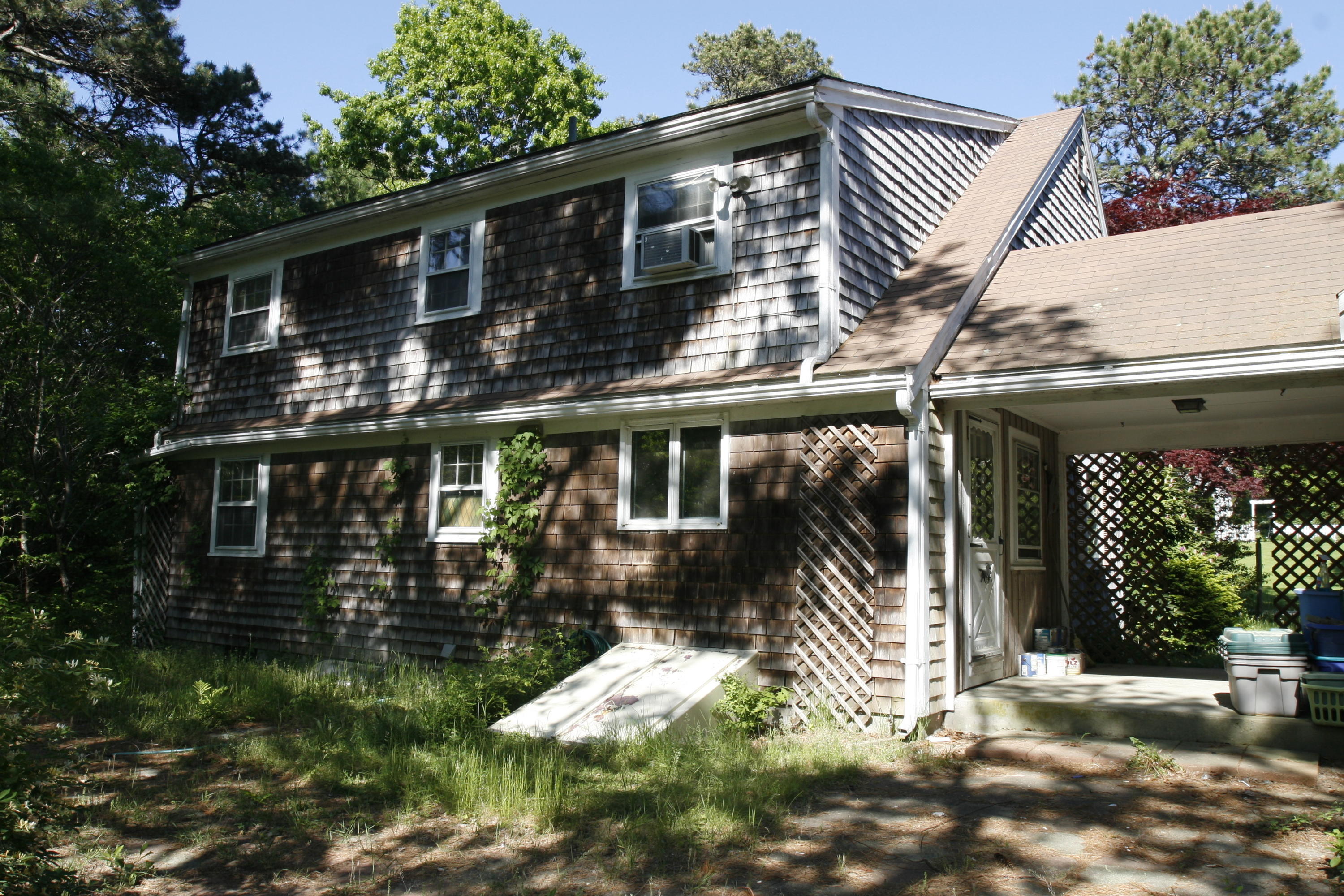 117 Turtleback Road Marstons Mills, MA 02648 - Photo 4 of 35 a backyard of a house with yard and outdoor seating