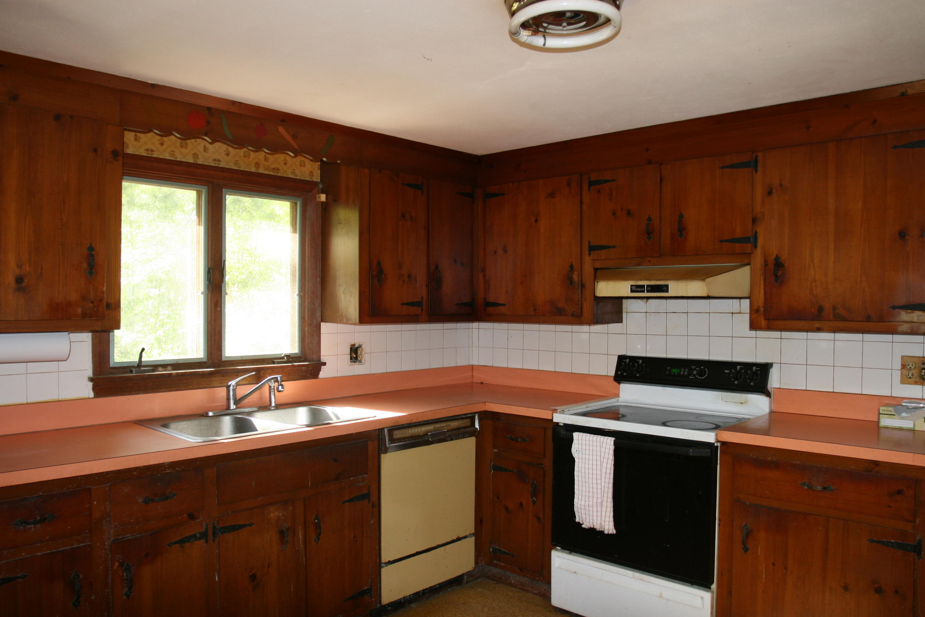 117 Turtleback Road Marstons Mills, MA 02648 - Photo 5 of 35 a kitchen with stainless steel appliances a stove a sink and a microwave