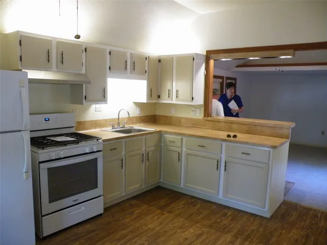 a kitchen with stainless steel appliances a refrigerator stove and sink
