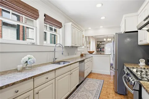 a living room with furniture flowerpot and a rug