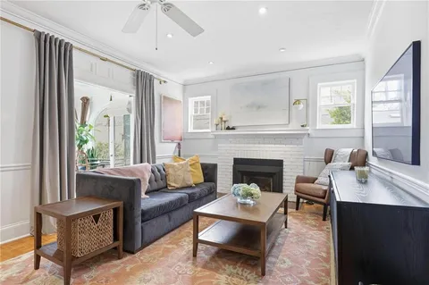 a bedroom with a bed table chair and a window