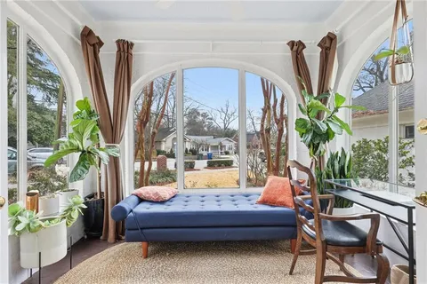 a living room filled with furniture and a potted plant