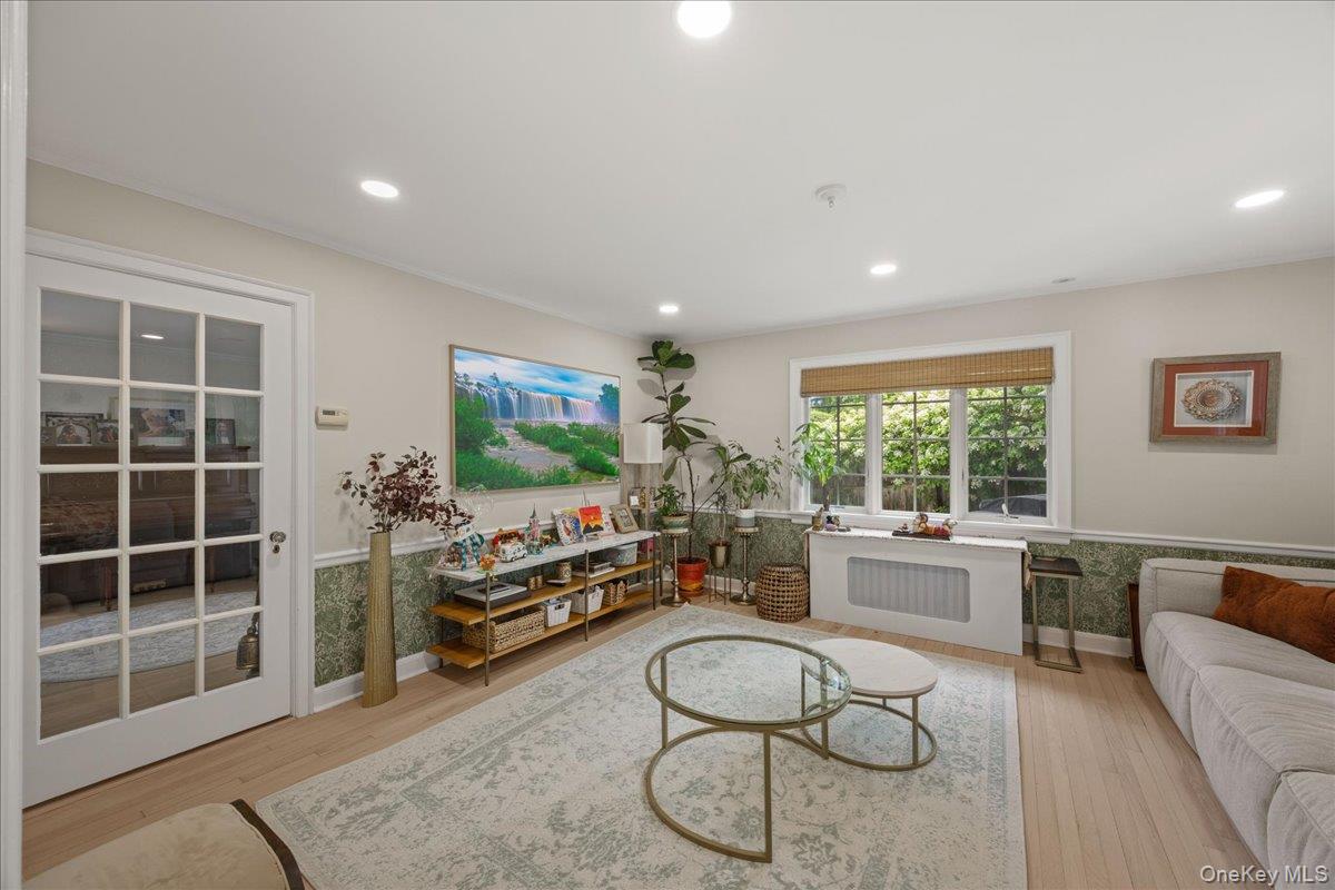 311 Lyncroft Road New Rochelle, NY 10804 - Photo 10 of 39 a living room with furniture a window and gym equipment