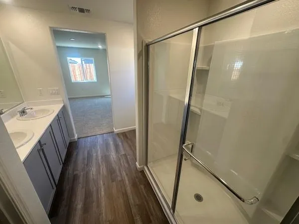 a view with a sink a mirror and a window