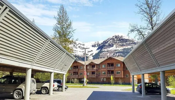 a view of a building with cars parked