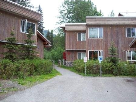 353 Hightower Road Other, AK 99587 - Photo 6 of 11 a view of a brick house with a yard plants and large tree